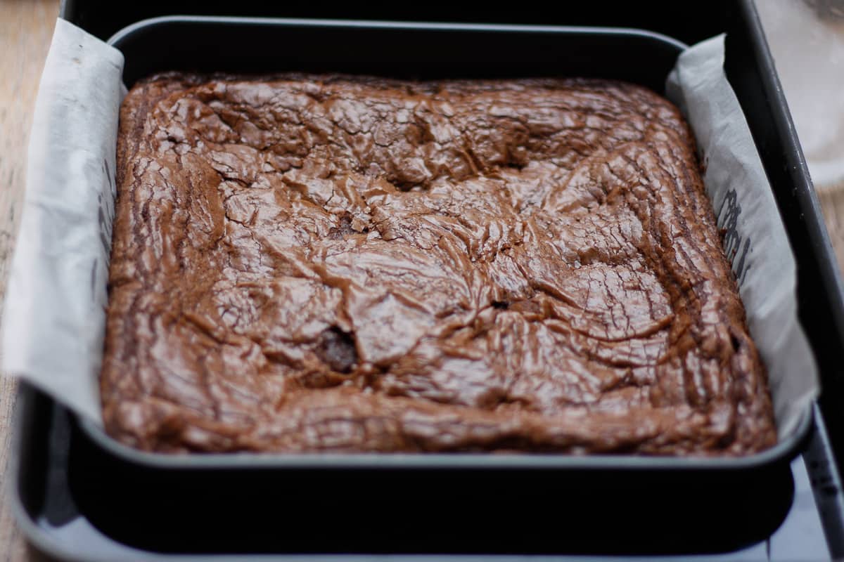 Brownies fresh out of the oven, placed in a water bath to cool.