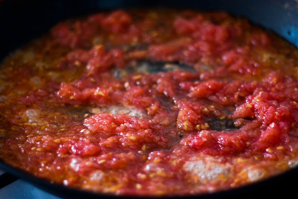 Tomato juice bubbling in a pan.