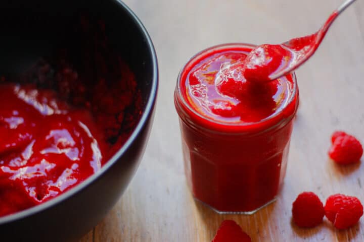 Raspberry sauce in a jam jar.