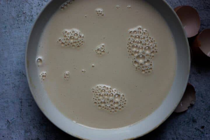 Batter in a white bowl, thin and smooth.