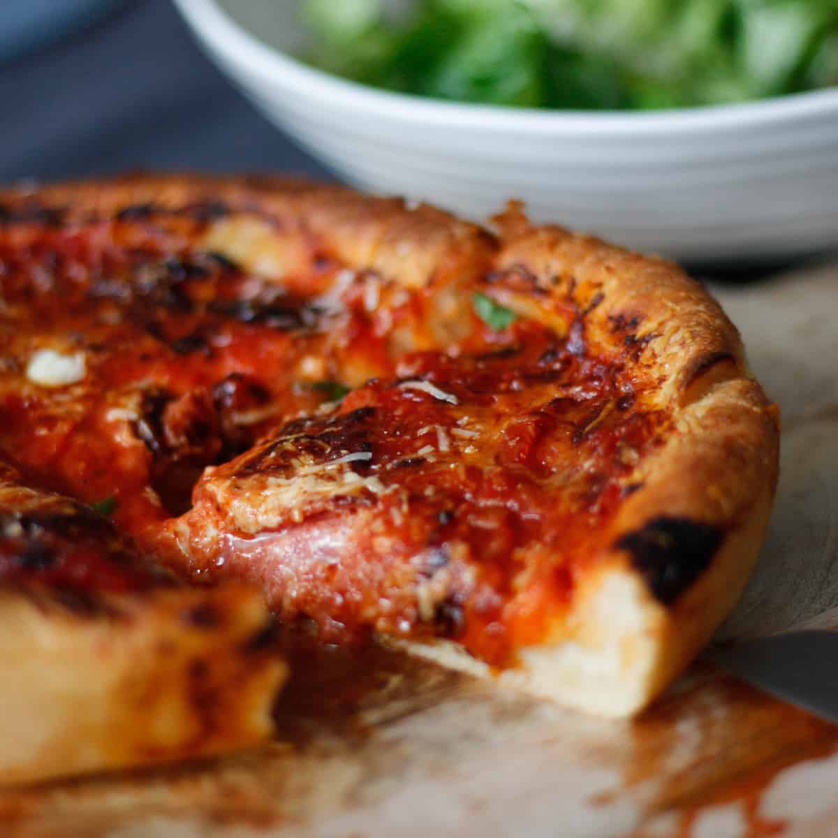 Slice of Chicago Pizza cut from the whole and pulled out slightly.